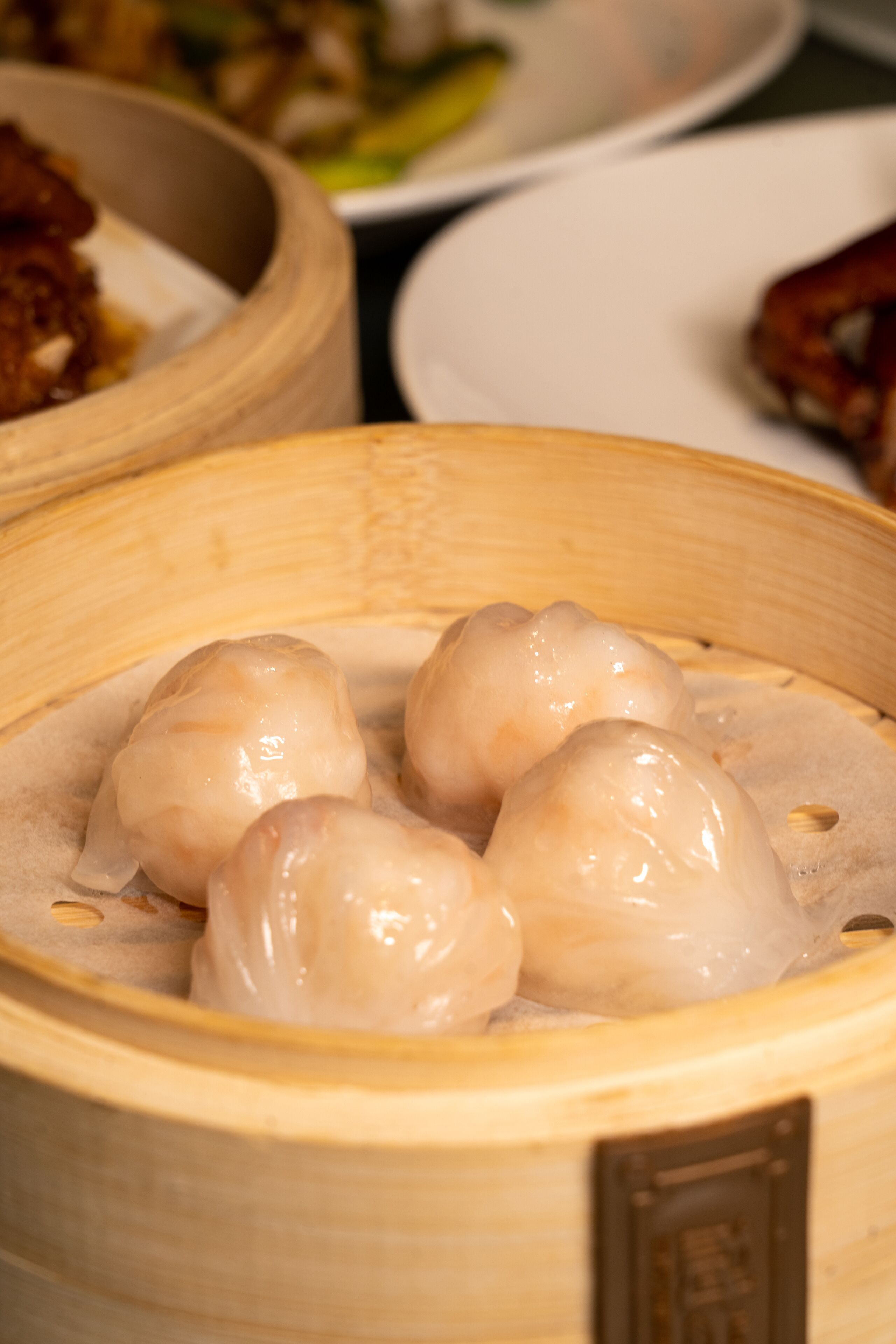 A bamboo steamer with several dumplings.
