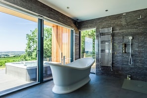 Executive Suite, 1 King Bed, Hot Tub | Bathroom | Separate tub and shower, deep soaking tub, rainfall showerhead