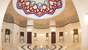 A spacious lobby with a large, ornate ceiling design, multiple bathrooms, and a central seating area with a patterned rug. - Side Prenses Resort Hotel & Spa - All Inclusive (Manavgat)