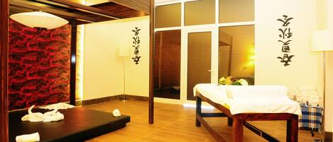 A traditional Japanese-style room with tatami flooring, a wooden bench, a massage table, and a shoji screen.