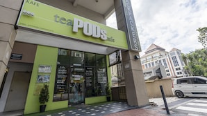 A building with a sign for 'teaPODS cafe' and a 'Backpackers' sign above it. - PODs The Backpackers Home & Cafe (Kuala Lumpur)