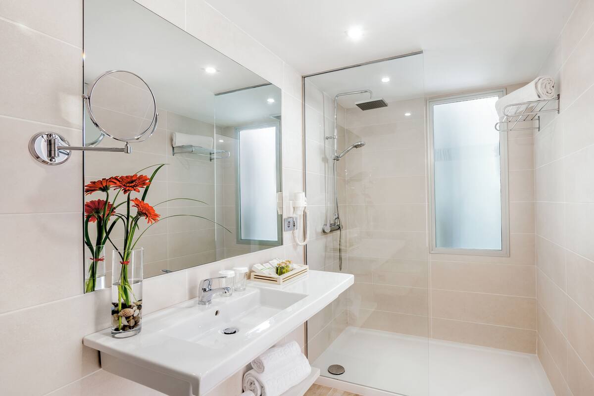 shower, rainfall showerhead, hair dryer, towels