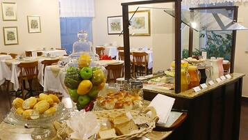 A buffet setup with various food items and a glass display case.