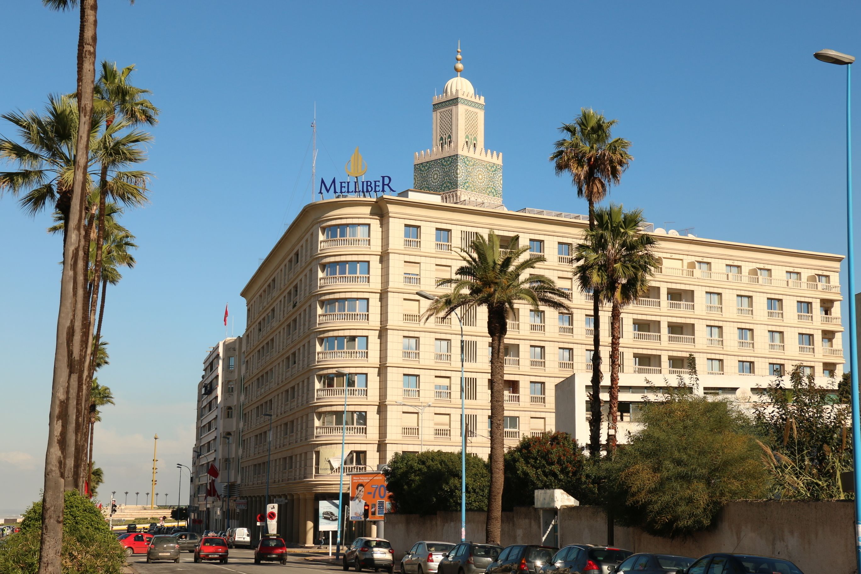 A large hotel with a prominent tower and multiple balconies.