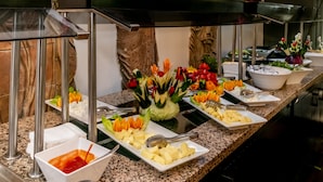 Un bufé con diversos alimentos y un centro de mesa decorativo.