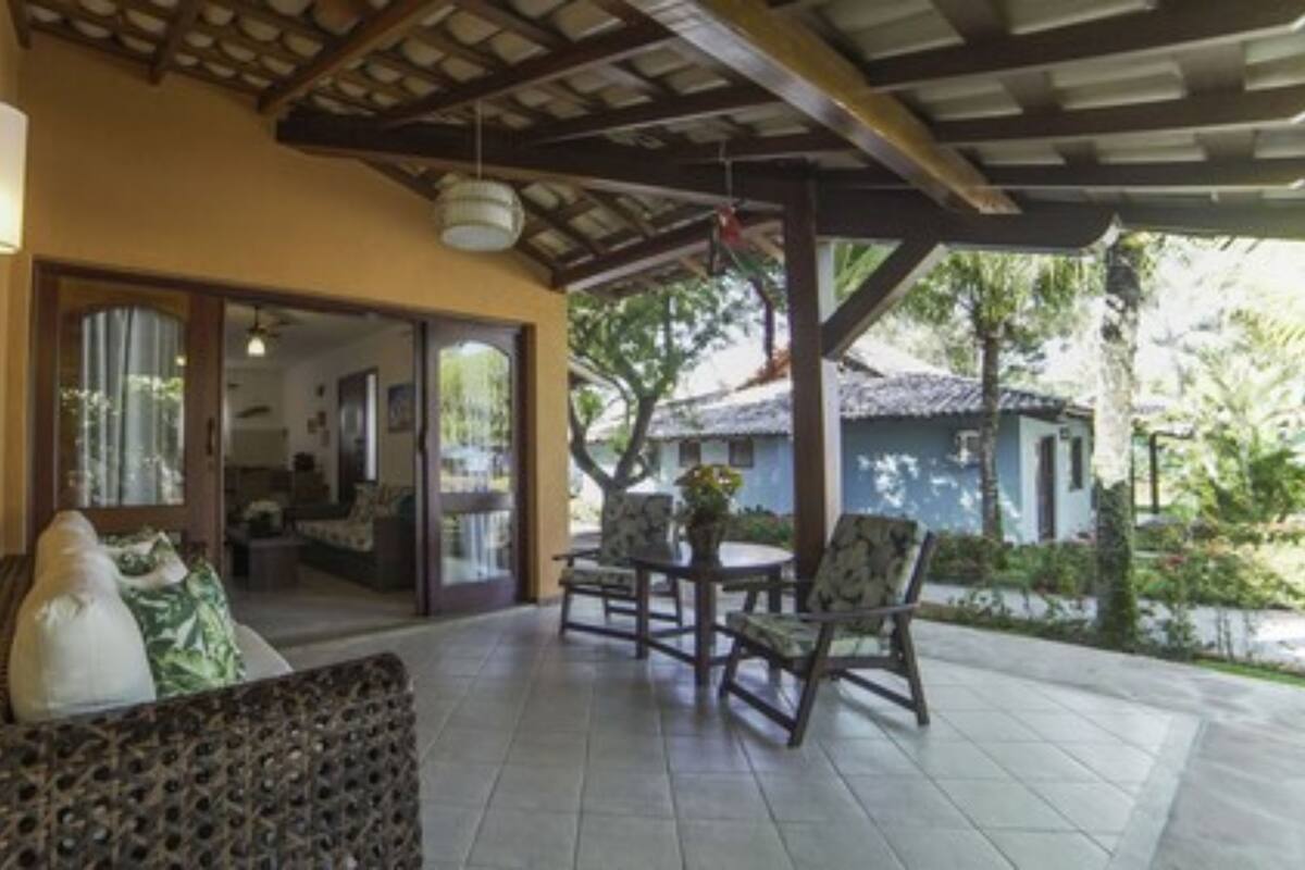 An outdoor patio area with a sofa, chairs, and a table.