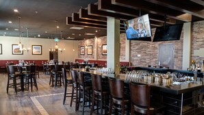 A restaurant with a bar area, multiple seating options, and a television screen mounted on the wall. - Four Points By Sheraton Sherwood Park (Sherwood Park)