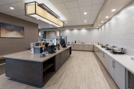 A modern kitchen with a central island, built-in appliances, and ample counter space.