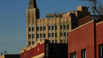 A multi-story building with a prominent tower and flag.