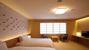 A hotel room with two beds, a TV, a desk, and a large window. - Shintamagawa Onsen (Senboku)