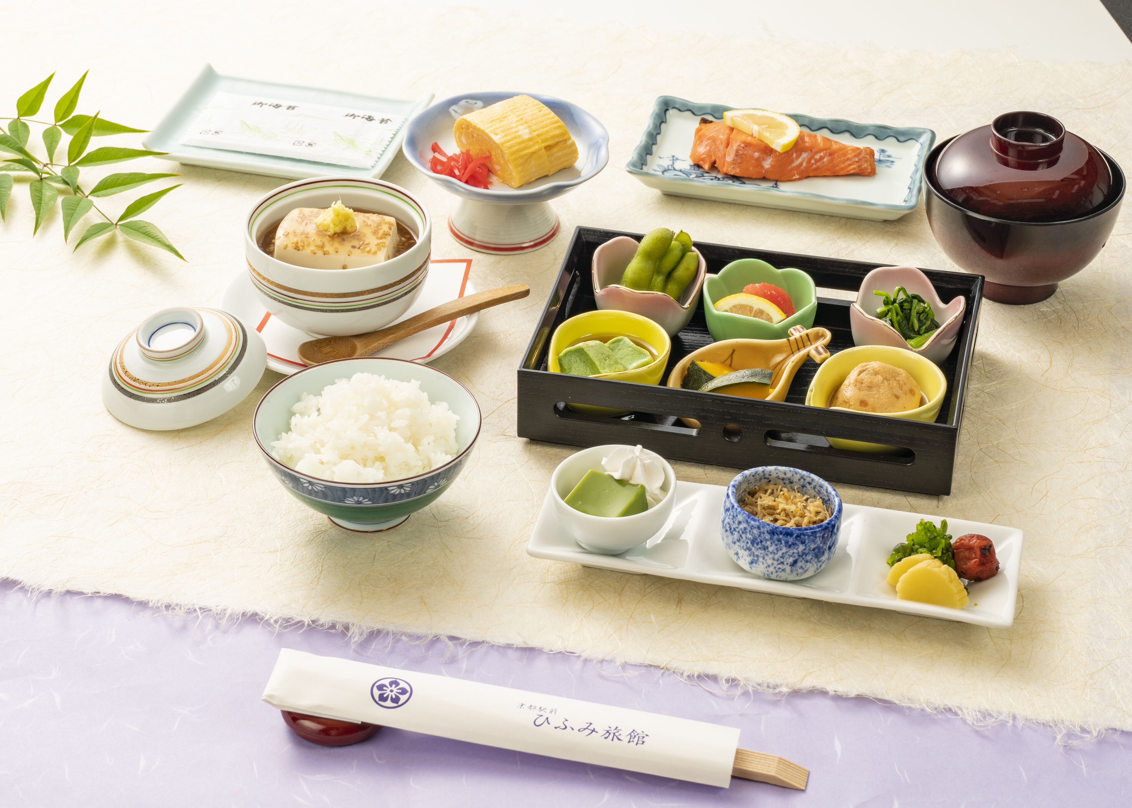 A traditional Japanese meal setup with various dishes and utensils.