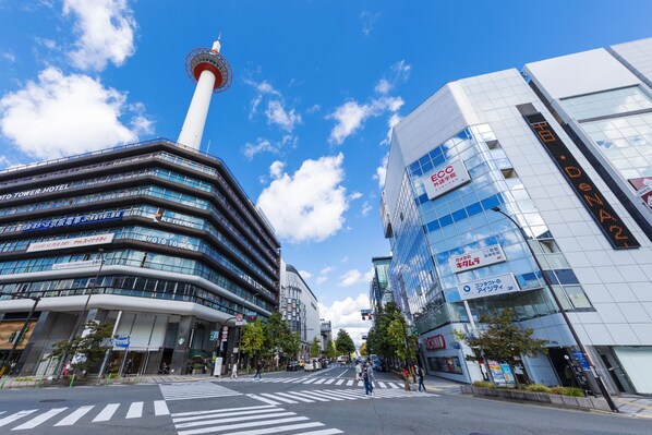 A modern hotel with a distinctive tower and a glass facade.