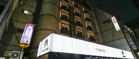 A hotel with a prominent sign reading "HOTEL PRIMO GRAND OPEN".