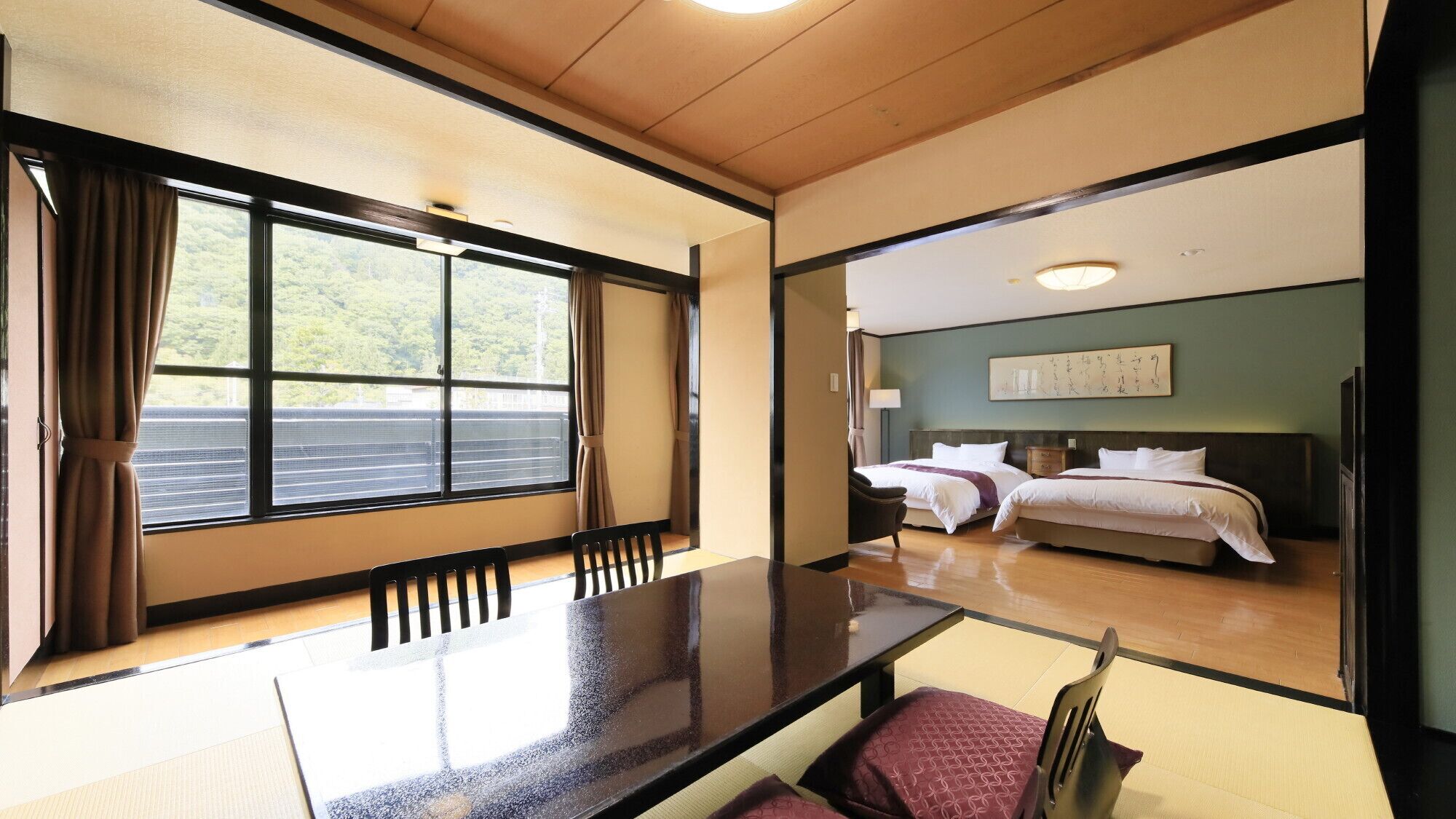 A hotel room with a large window, a bed, a bedside table, and a chair.