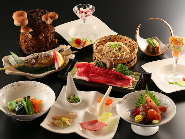 A variety of dishes including sushi, sashimi, and a bowl of soup. - Ryokan Biyunoyado (Yamanouchi)