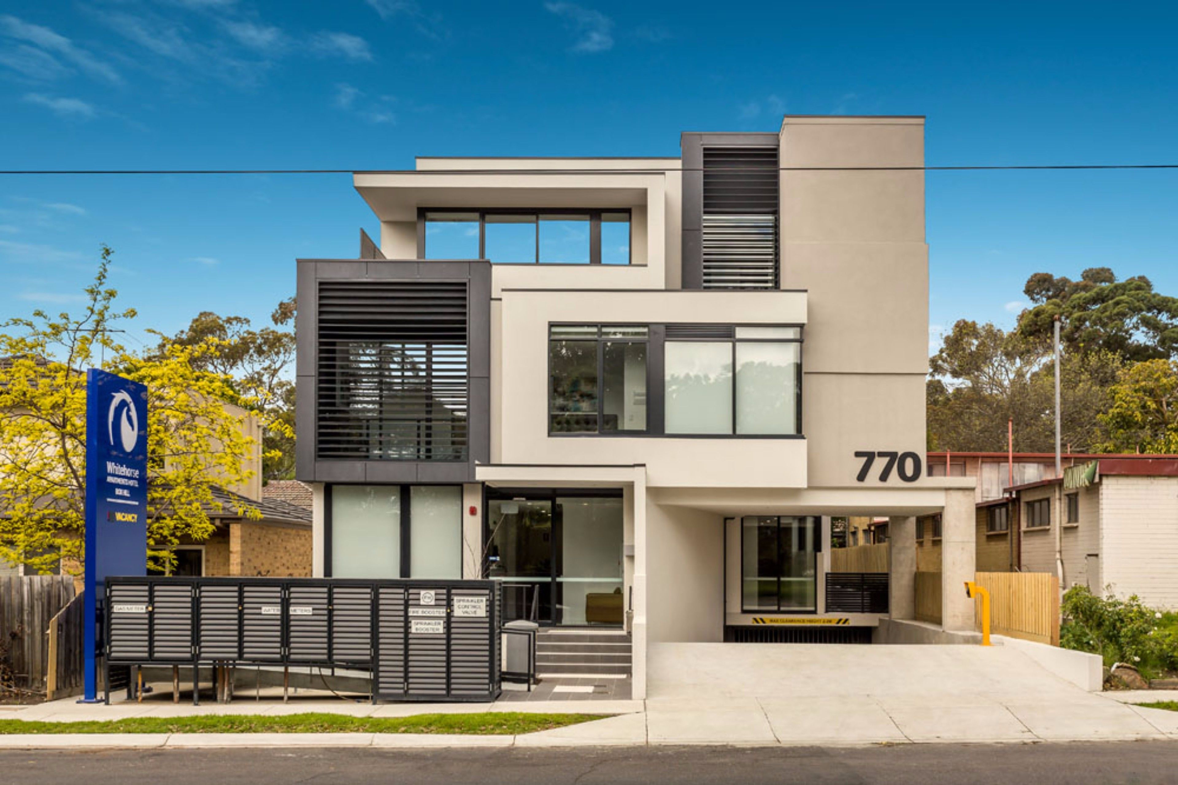 A modern building with a flat roof, large windows, and a number '770' on the facade.