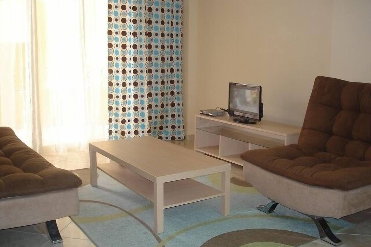 Apartment, 1 Bedroom | Living room | Flat-screen TV