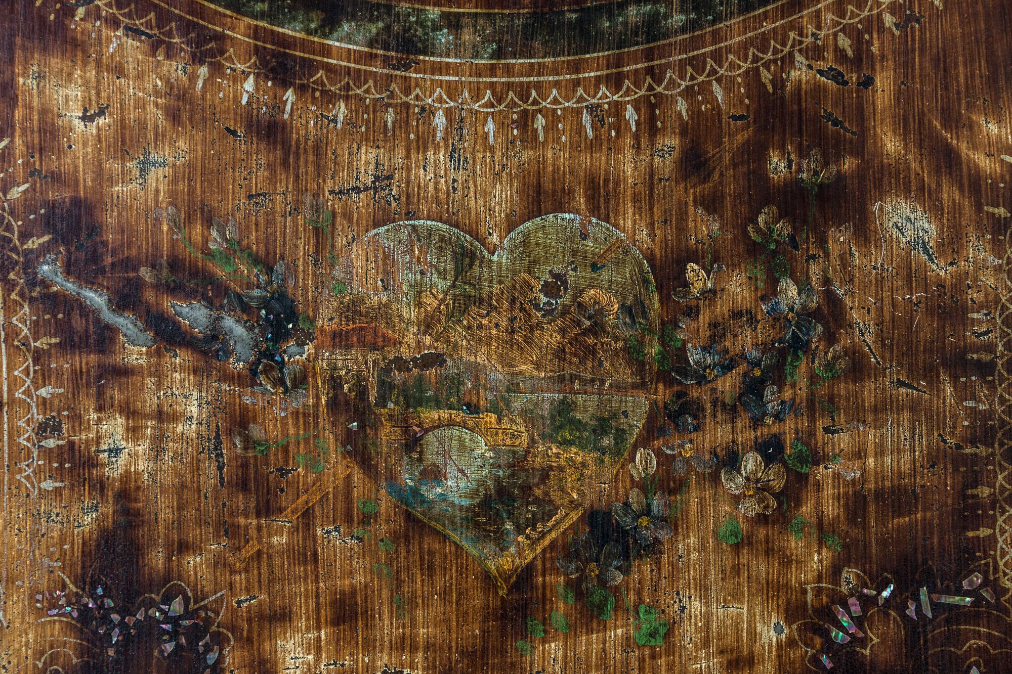 A wooden surface with a heart-shaped design and decorative elements.