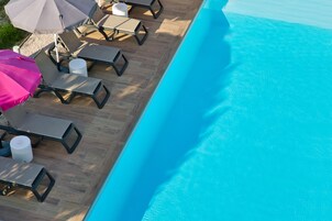 Seasonal outdoor pool, open 9:00 AM to 9:00 PM, pool umbrellas