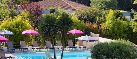 Seasonal outdoor pool, open 9:00 AM to 9:00 PM, pool umbrellas