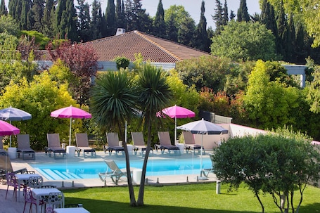 Seasonal outdoor pool, open 9:00 AM to 9:00 PM, pool umbrellas