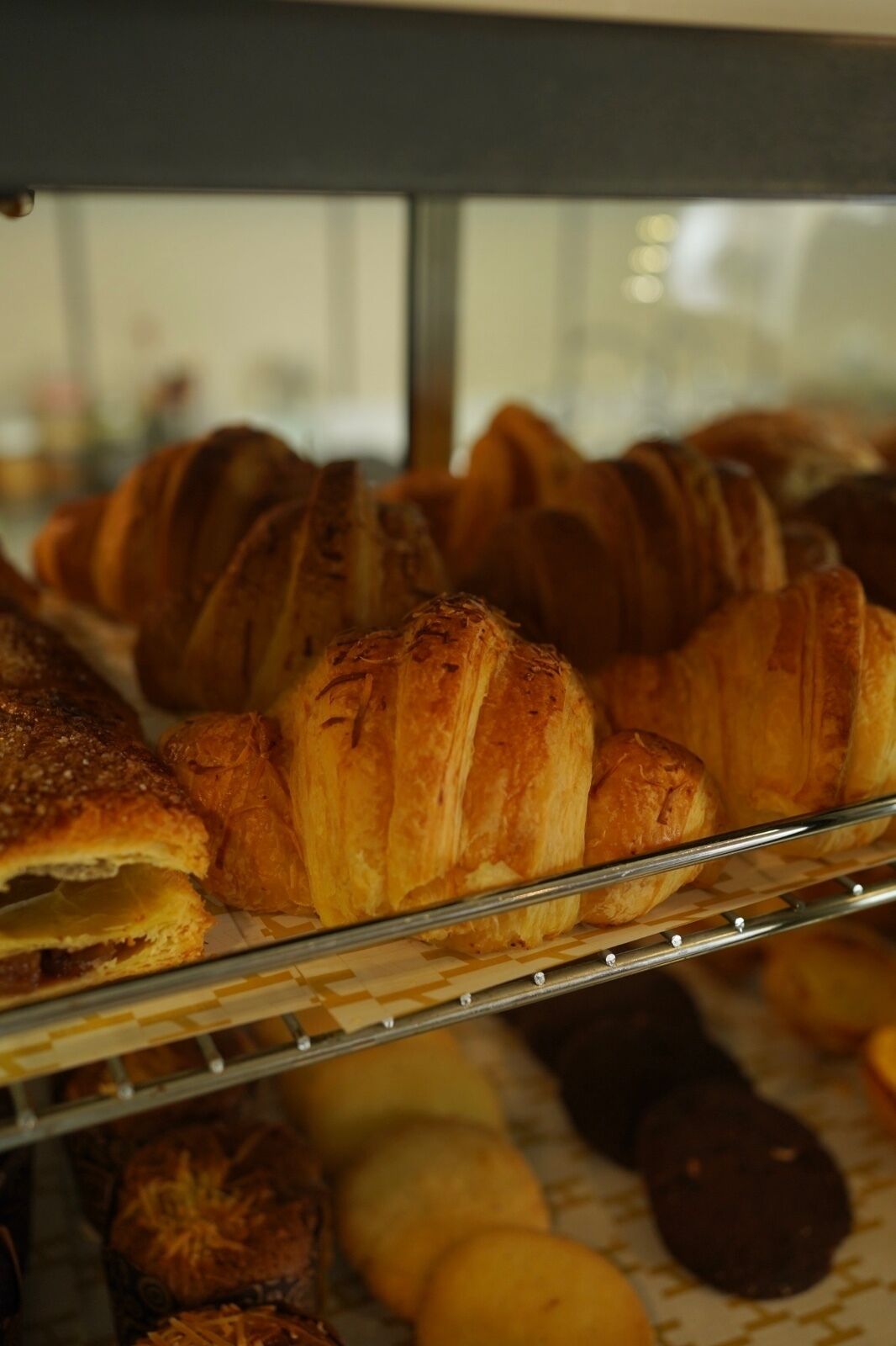 A bakery display case with various baked goods.