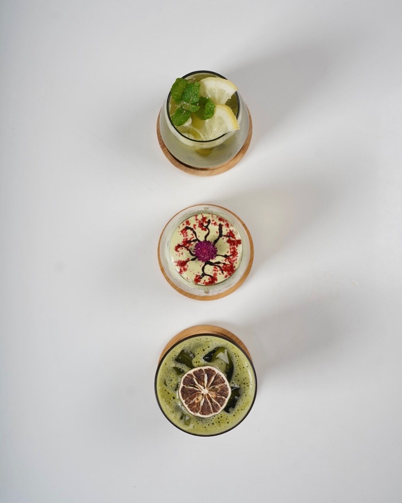 Three drinks on a white surface.