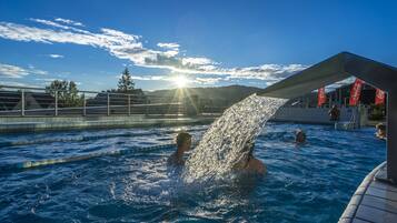 Guests can enjoy a refreshing swim in the pool surrounded by a sunny sky.