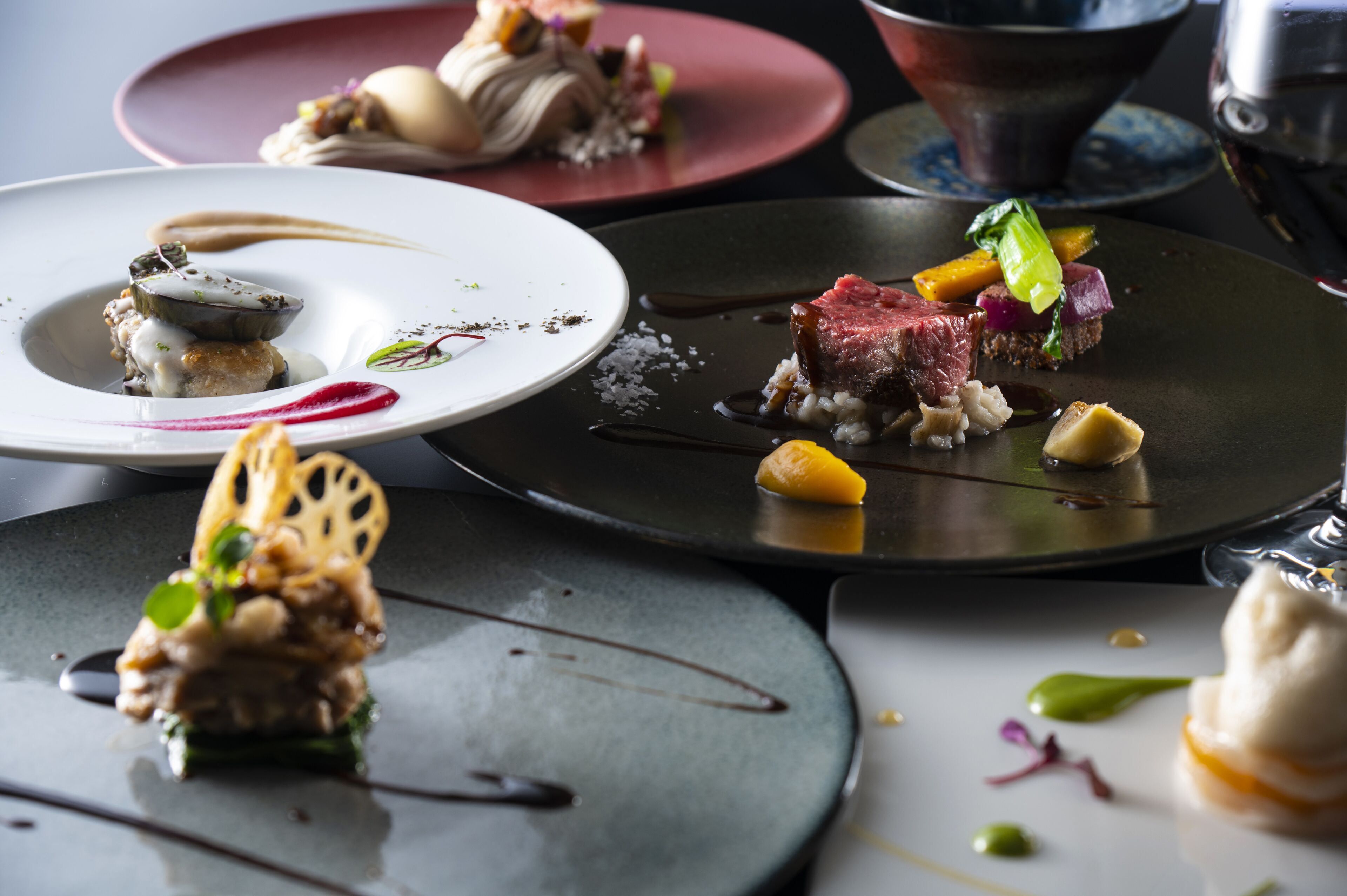 A variety of plated dishes with different colors and textures.