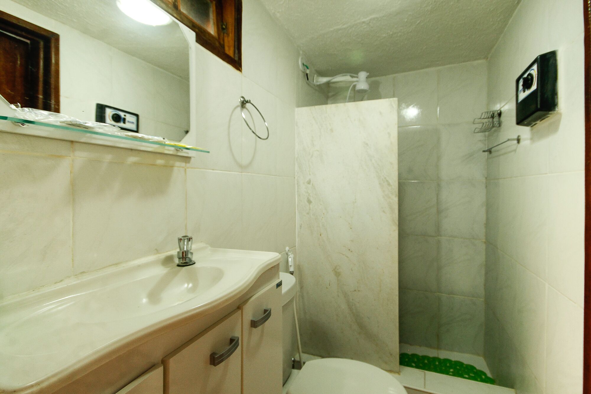 A bathroom with a sink, toilet, and shower.
