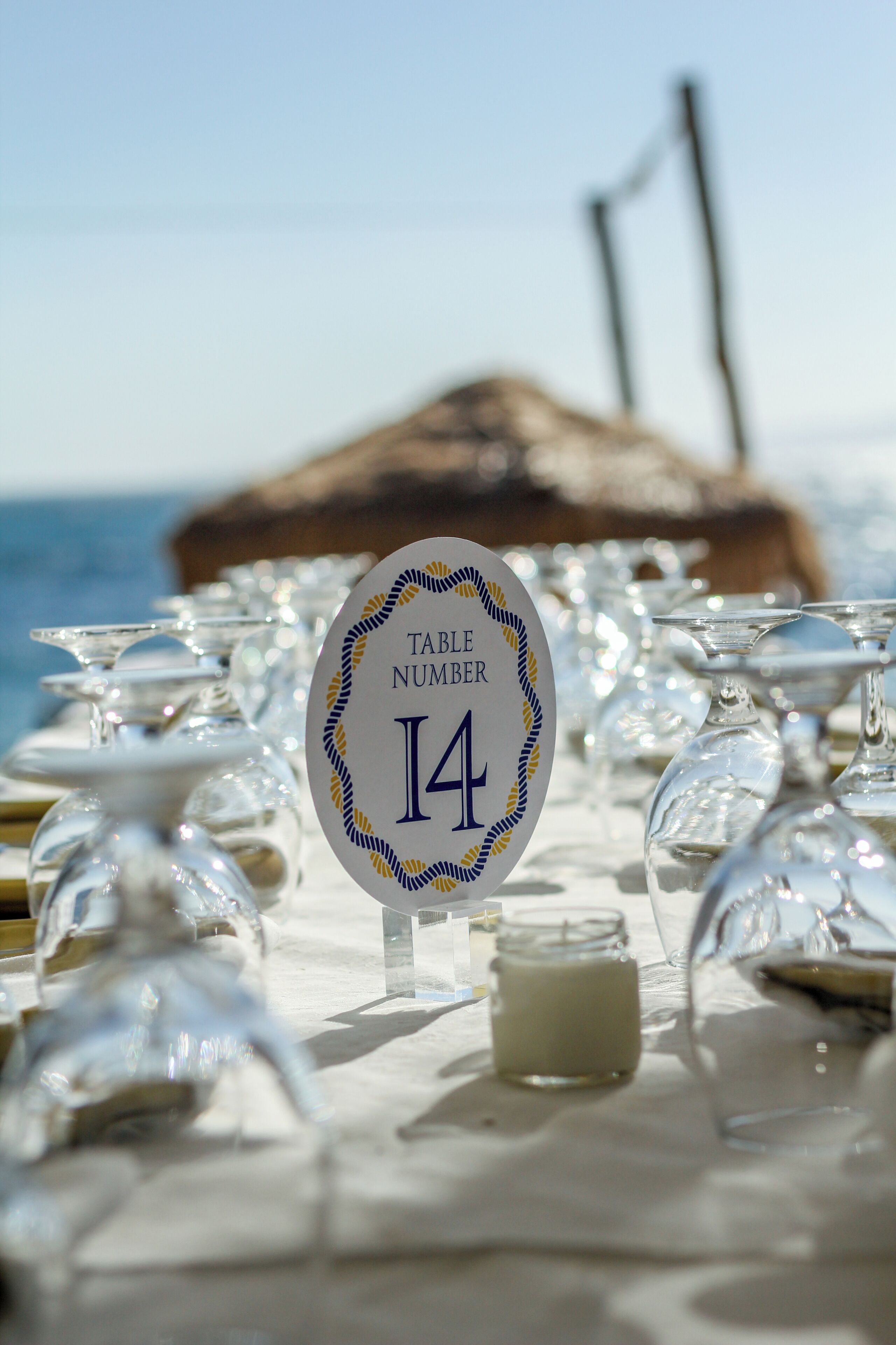 A table with a sign indicating 'Table Number 14' and a candle on the table.