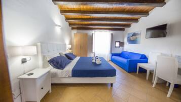 Superior Triple Room, Sea View | Minibar, individually decorated, desk, soundproofing