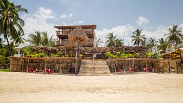 On the beach, white sand, sun-loungers, beach umbrellas