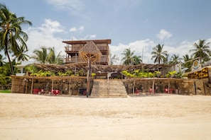 On the beach, white sand, sun loungers, beach umbrellas