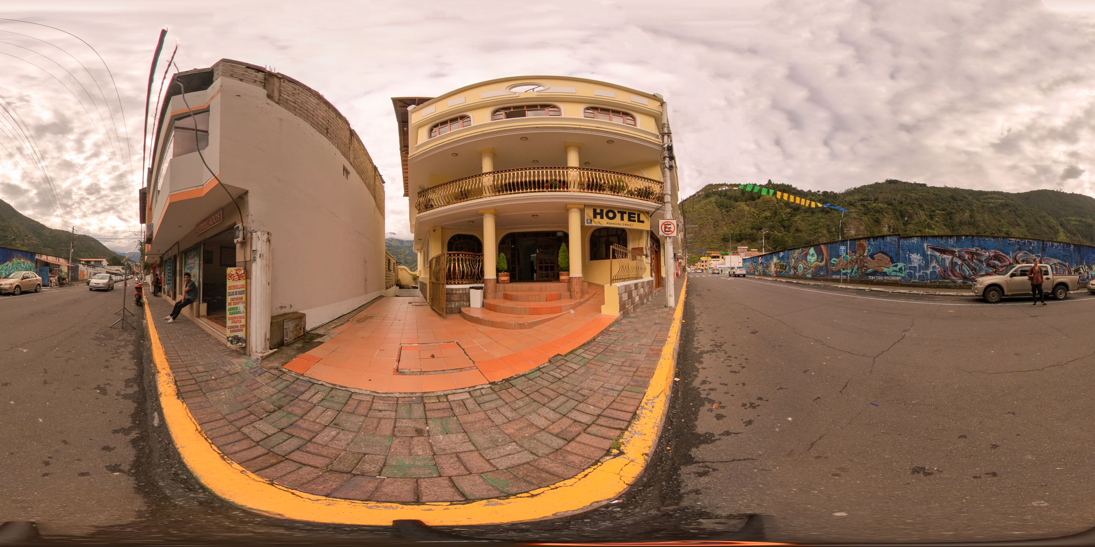 A hotel with a two-story structure, a balcony on the upper floor, and a sign indicating it is a hotel.