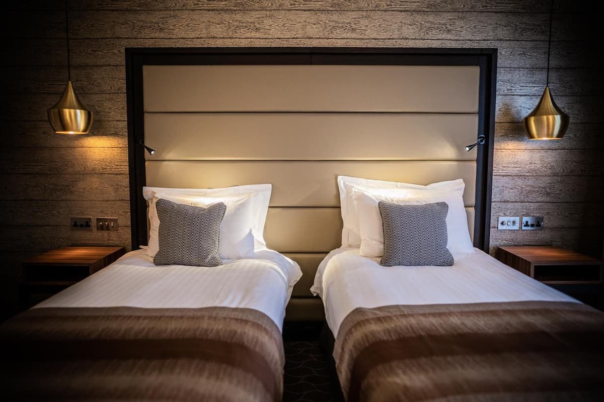 standard twin room | in-room safe, desk, blackout curtains, iron/ironing board