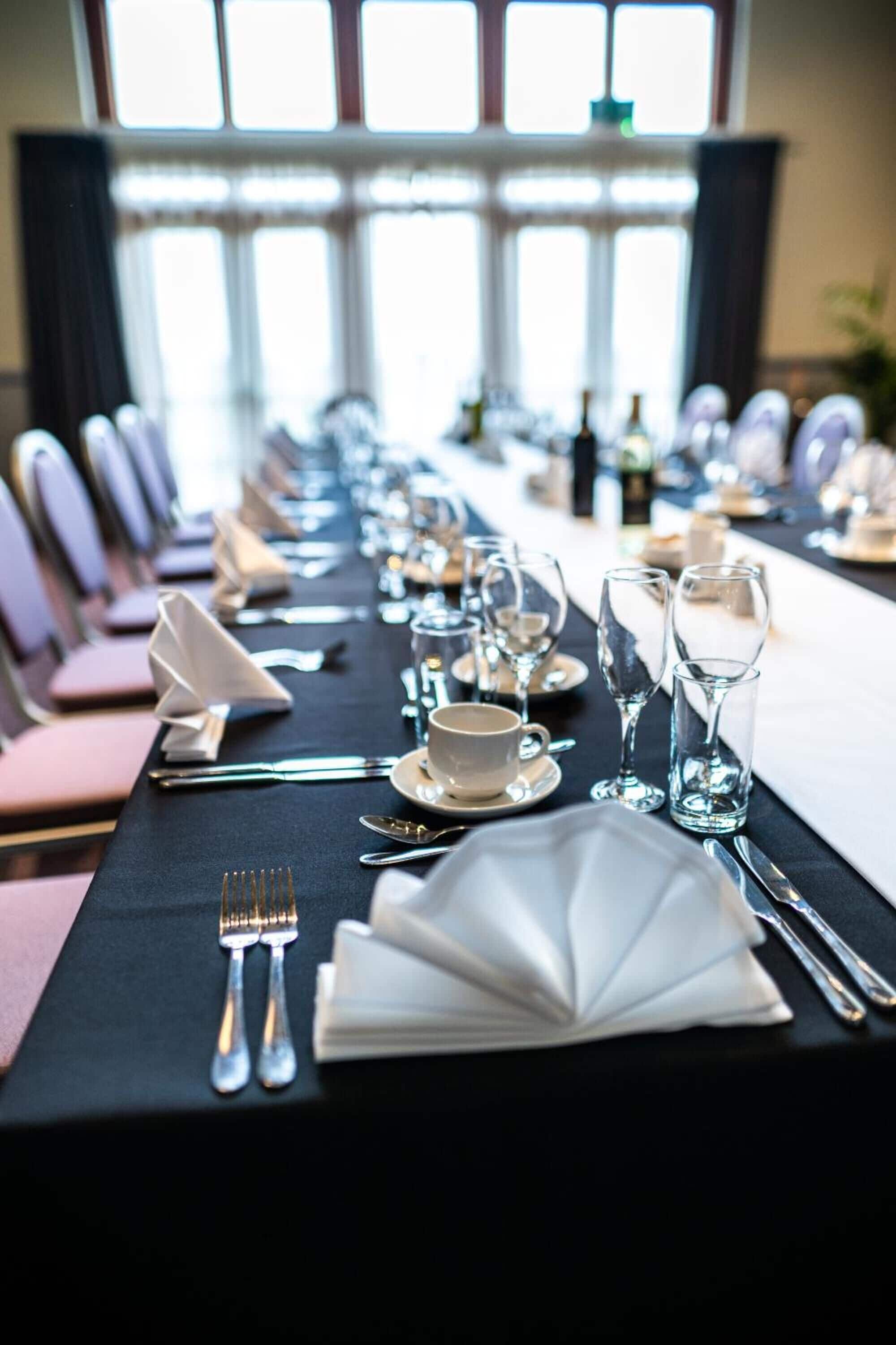 A conference room with a long table set for a meeting.