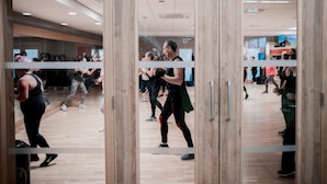 A dance studio with mirrored walls, wooden floors, and a central aisle. - The Warwickshire Hotel and Country Club (Warwick)