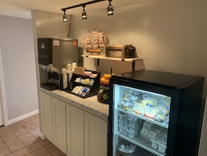 Prepare simple meals and snacks in this kitchenette, equipped with a coffee machine, refrigerator, and sink.
