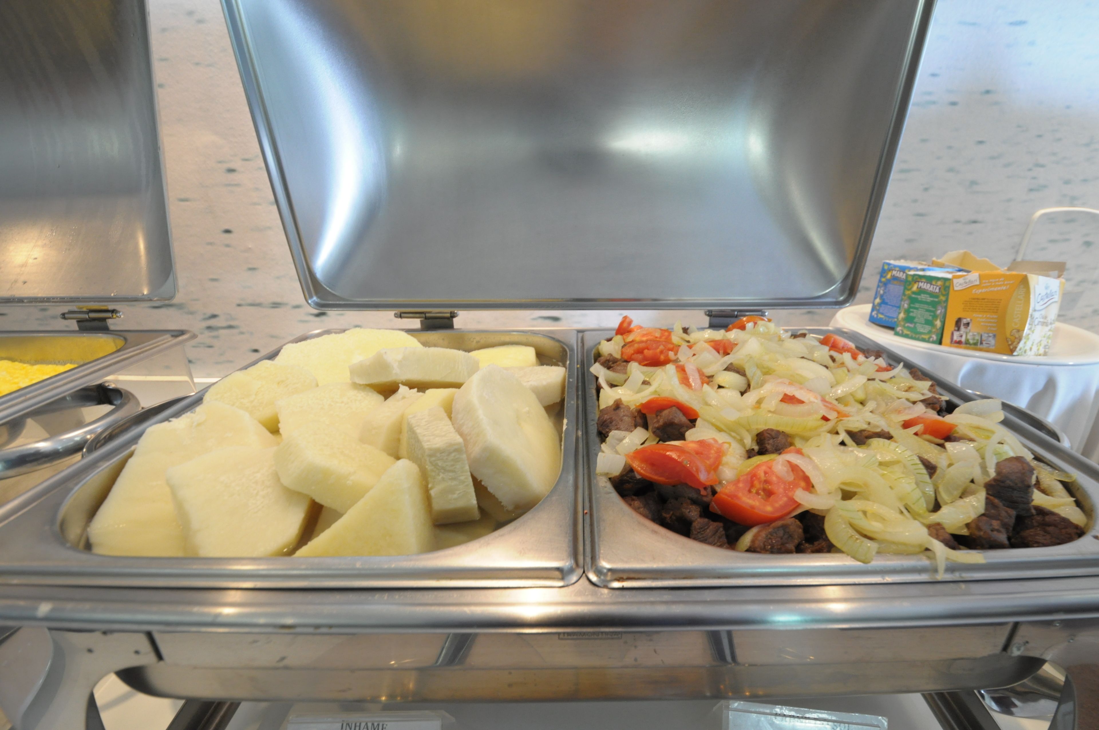 A buffet with various food items including potatoes, meat, and vegetables.