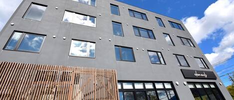 A modern building with multiple windows and a sign that reads "element".