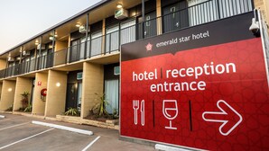 La entrada de recepción del hotel con un cartel que indica la dirección.