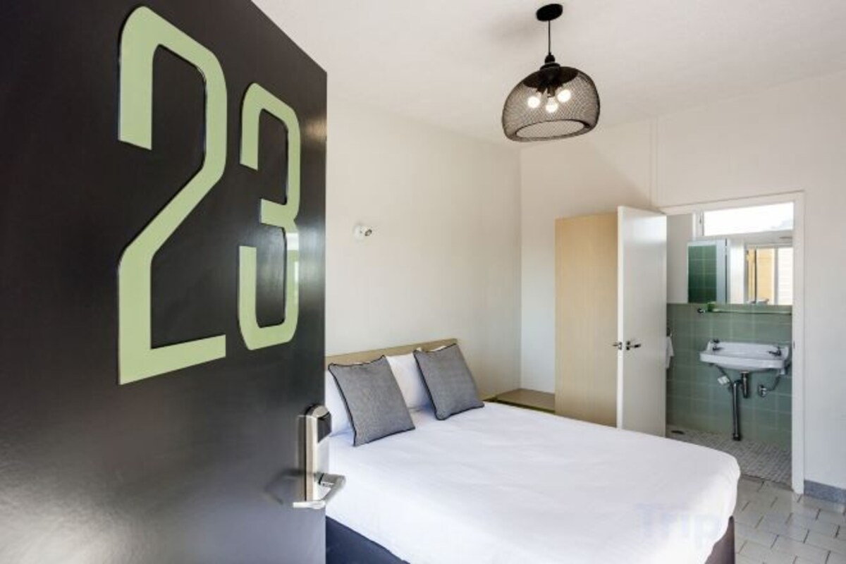 Minibar, escritorio, tabla de planchar con plancha y ropa de cama