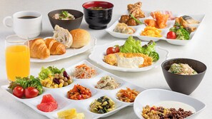 A variety of breakfast items including croissants, fruits, vegetables, and beverages on a table. - Seagaia Forest Cottages (Miyazaki)