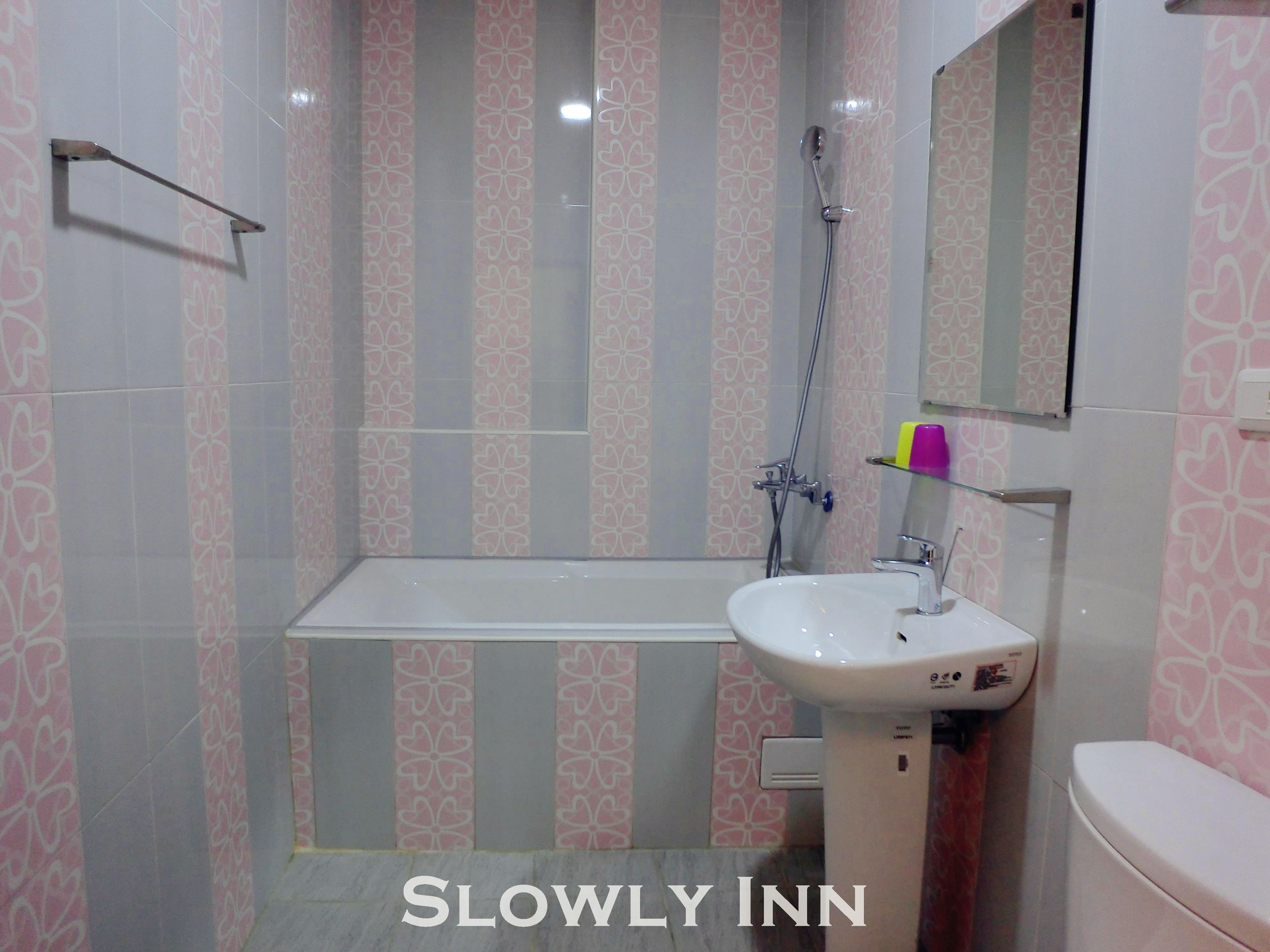 A bathroom with a bathtub, a sink, and a toilet.