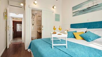 A bedroom with a bed, a nightstand, and a painting on the wall.