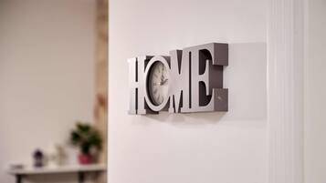 A wall-mounted sign with the word "HOME" in large, metallic letters.