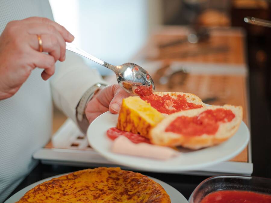 A person serving food from a plate.