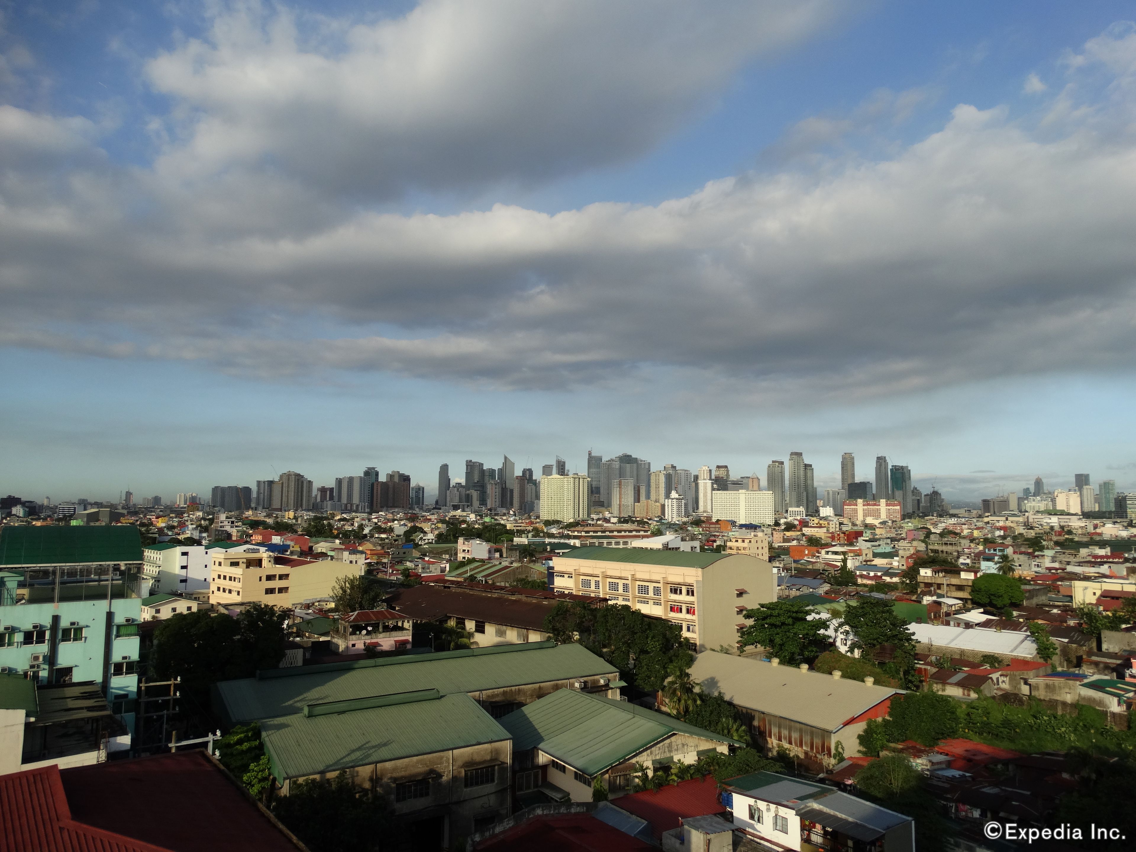 A cityscape with a mix of high-rise buildings and smaller residential structures.