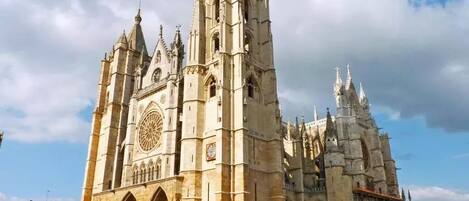 A large cathedral with a prominent rose window and multiple spires.
